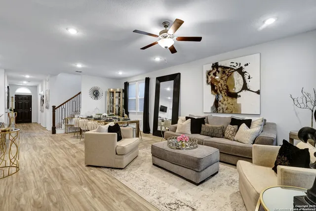 a living room with furniture and kitchen view
