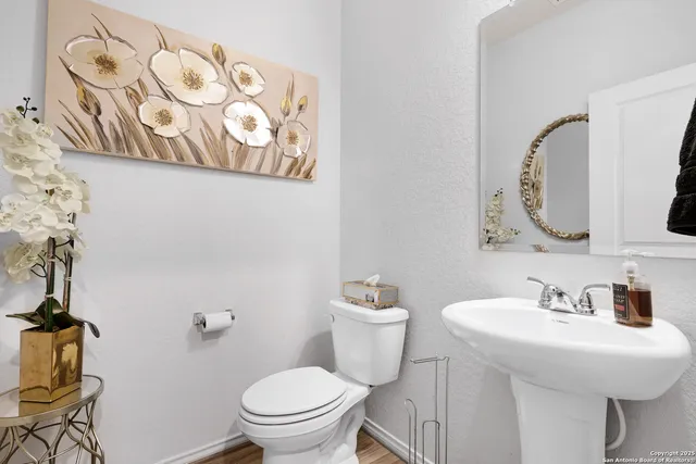 a bathroom with a toilet sink and mirror