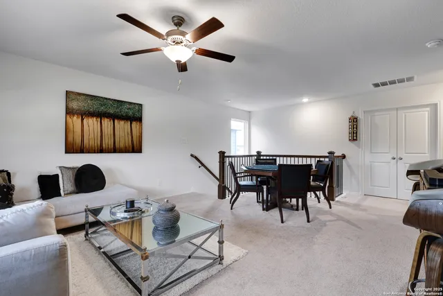 a living room with furniture a rug and a chandelier