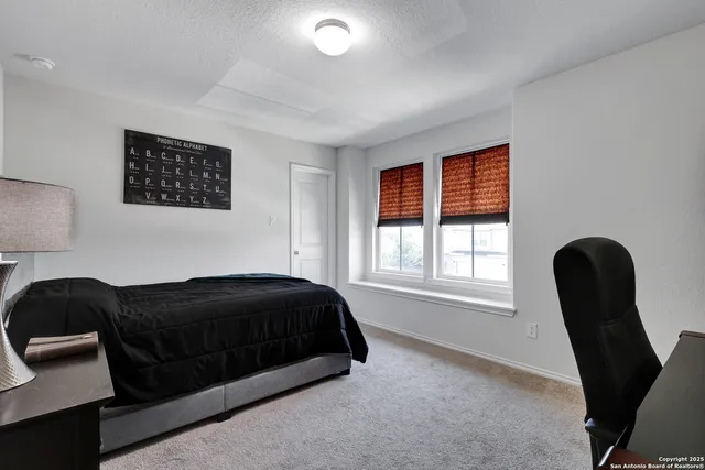 a bedroom with a bed and a chair