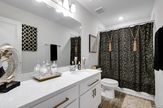 a bathroom with a sink toilet and shower