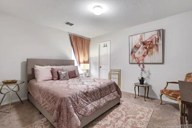 a bedroom with a bed and a lamp on table