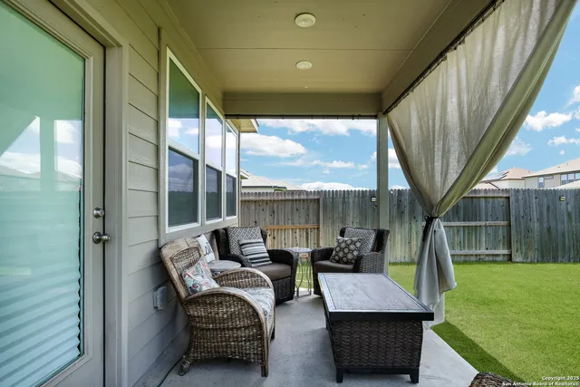 a balcony with furniture and a garden