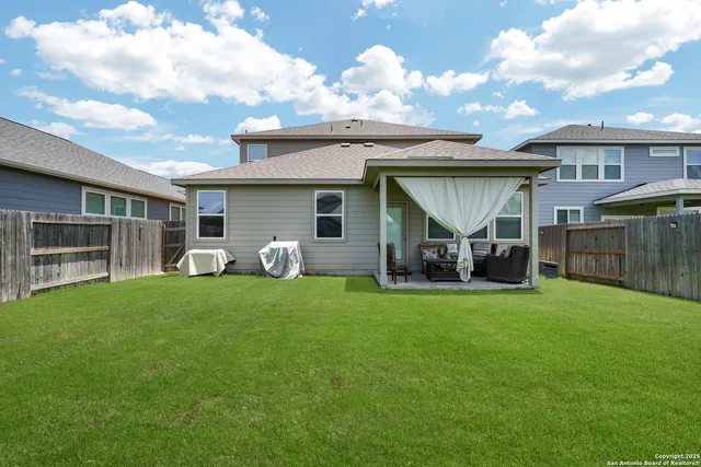 a view of a house with backyard and porch