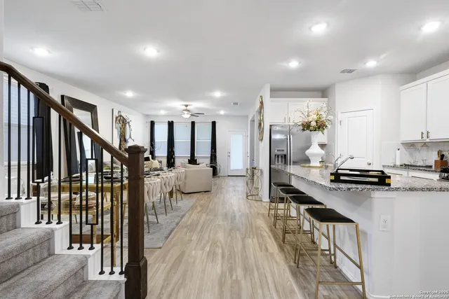 a open kitchen with stainless steel appliances granite countertop a stove and a refrigerator