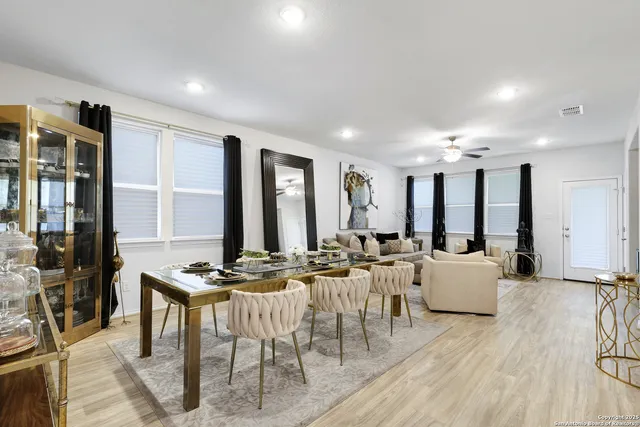 a view of a a dining room with furniture window and wooden floor