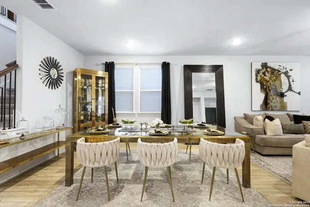 a living room with furniture and large windows