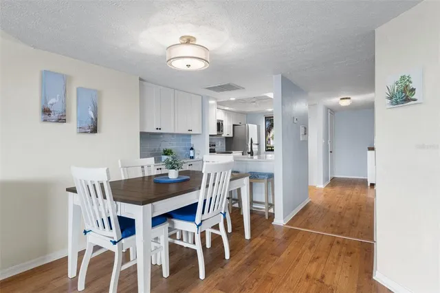 a dining room with furniture and wooden floor