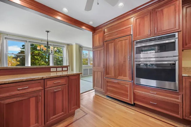 a kitchen with stainless steel appliances granite countertop a refrigerator and a stove top oven