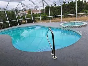 a view of a swimming pool with a sink and wooden fence