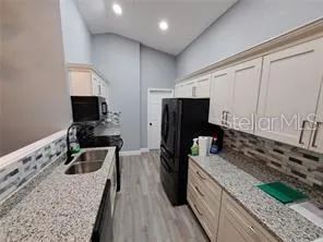 a kitchen with stainless steel appliances granite countertop a stove and a sink