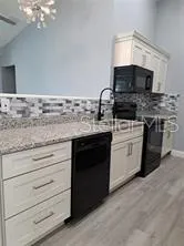 a kitchen with a stove a refrigerator and a sink