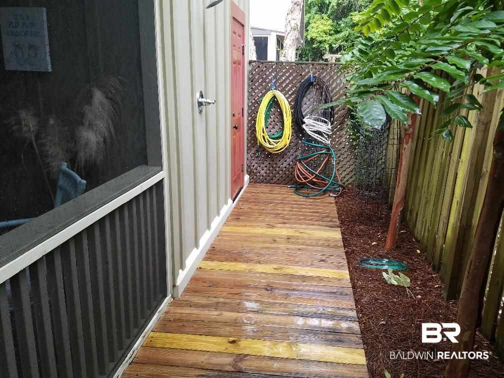 25773 Canal Road, Unit 41 Orange Beach, AL 36561 - Photo 21 of 34 New Walkway to Storage and Outdoor Shower