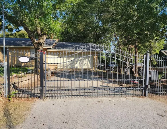 a view of a yard with wooden fence
