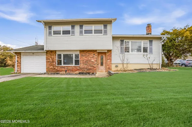 a front view of house with yard and green space