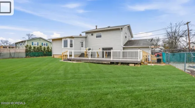 a view of a house with a big yard and large trees