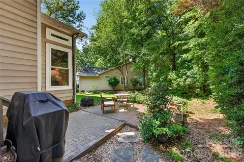 a view of backyard with outdoor seating and a garden