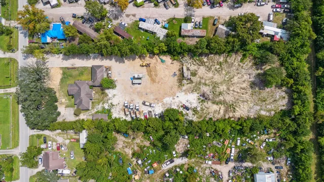an aerial view of residential house with outdoor space and trees all around