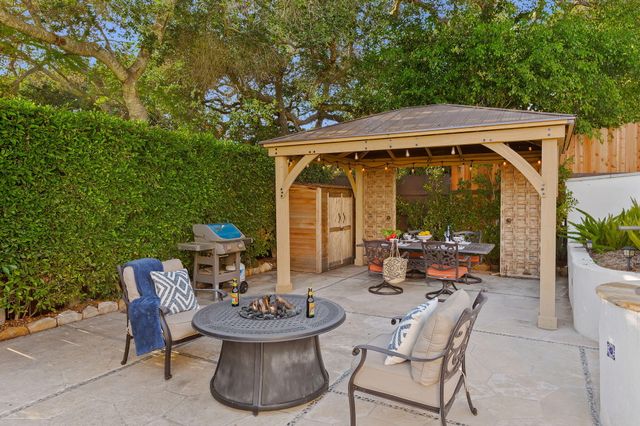 a backyard of a house with outdoor seating