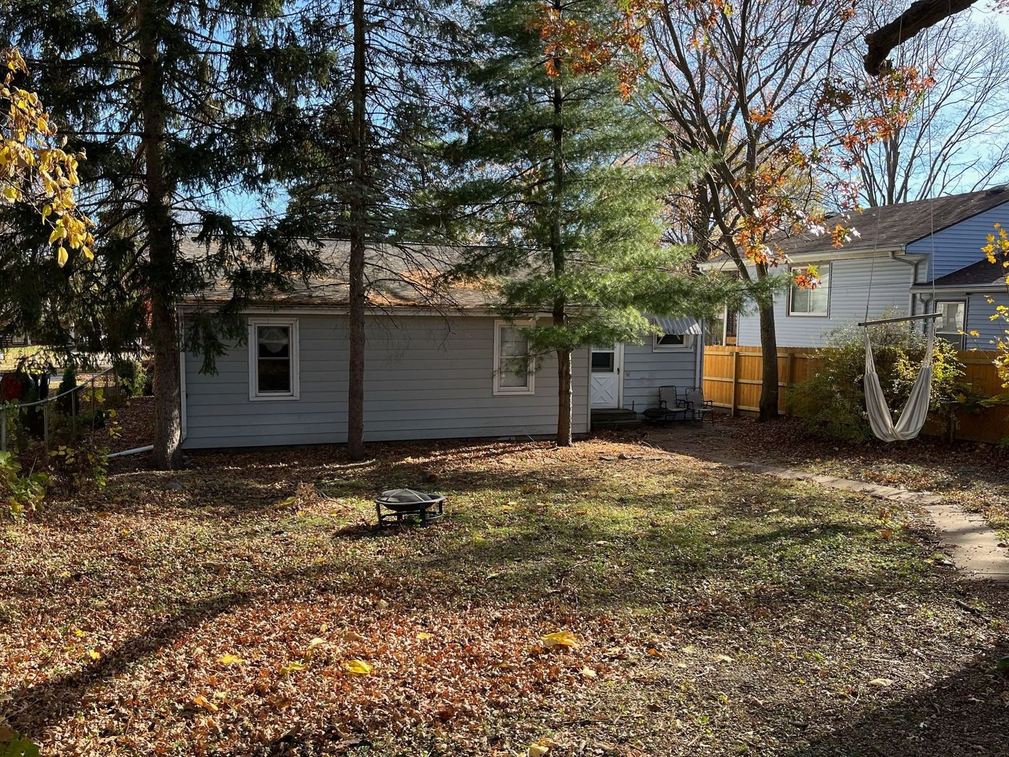 1011 Franklin Avenue Normal, IL 61761 - Photo 14 of 15 a backyard of water house with large trees and bench