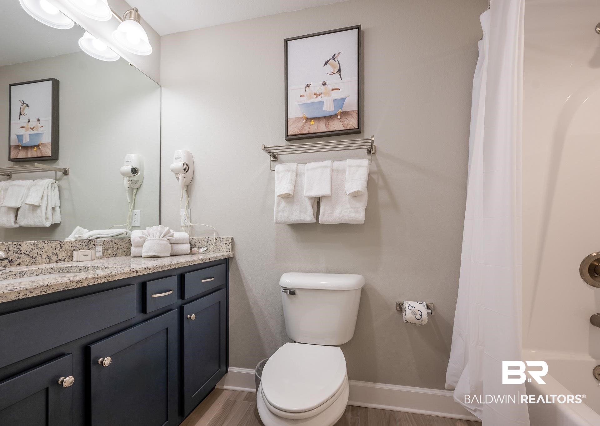 23008 Perdido Beach Boulevard, Unit 506 Orange Beach, AL 36561 - Photo 17 of 48 Full bath with vanity, baseboards, toilet, and wood finished floors