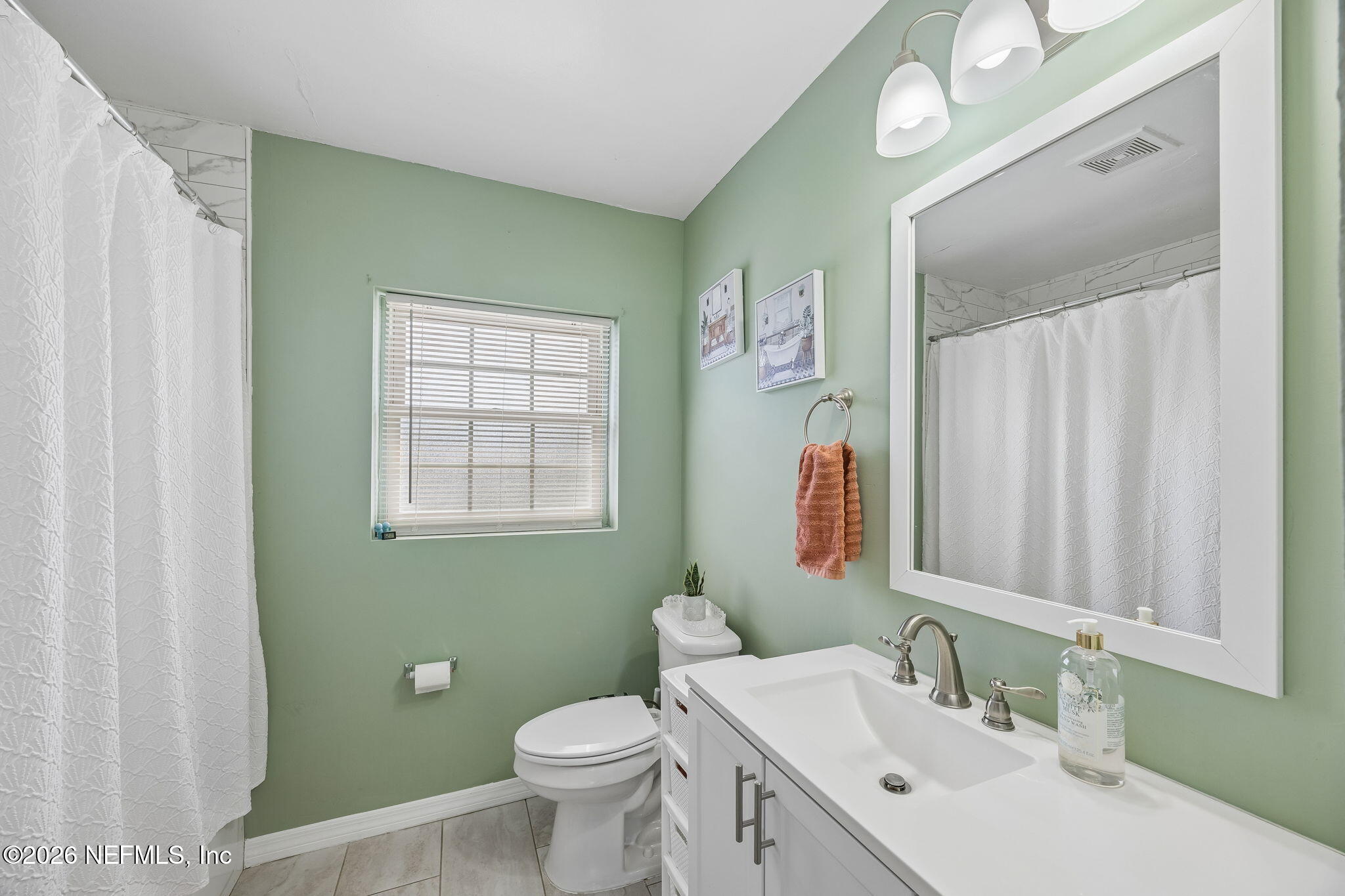 7022 Gaillardia Road South Jacksonville, FL 32211 - Photo 23 of 32 a bathroom with a double vanity sink toilet and a mirror