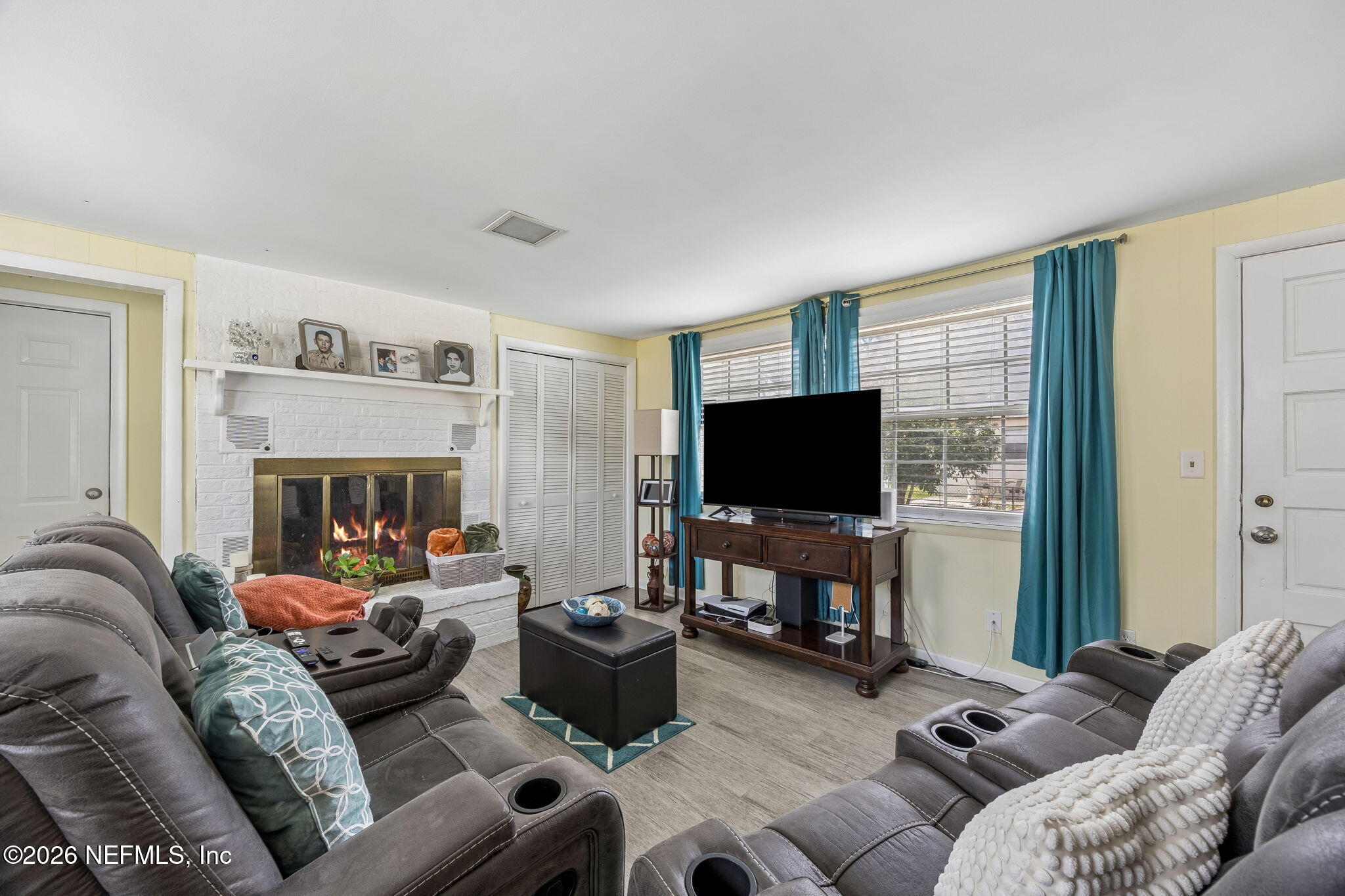 7022 Gaillardia Road South Jacksonville, FL 32211 - Photo 9 of 32 a living room with furniture and a flat screen tv