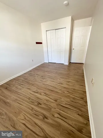 an empty room with wooden floor