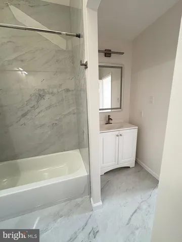 a bathroom with a sink a mirror and a bathtub