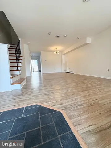 a view of a room with wooden floor