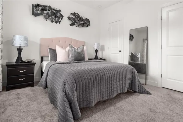 a spacious bedroom with a bed and a table in it