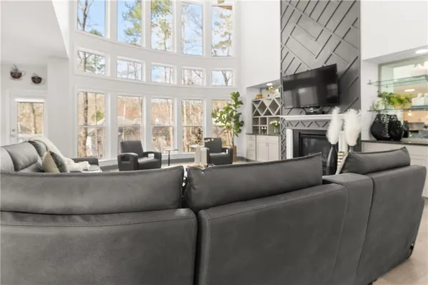 a living room with furniture gym equipment and a large window