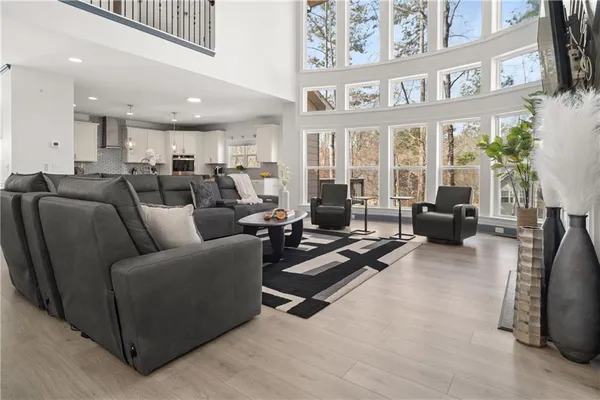 a kitchen with stainless steel appliances kitchen island granite countertop a stove a sink a refrigerator and white cabinets