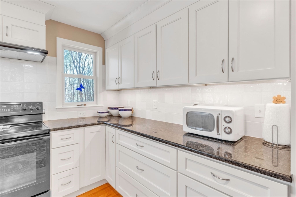 213 North Valley Road Pelham, MA 01002 - Photo 13 of 42 a kitchen with granite countertop white cabinets and white appliances