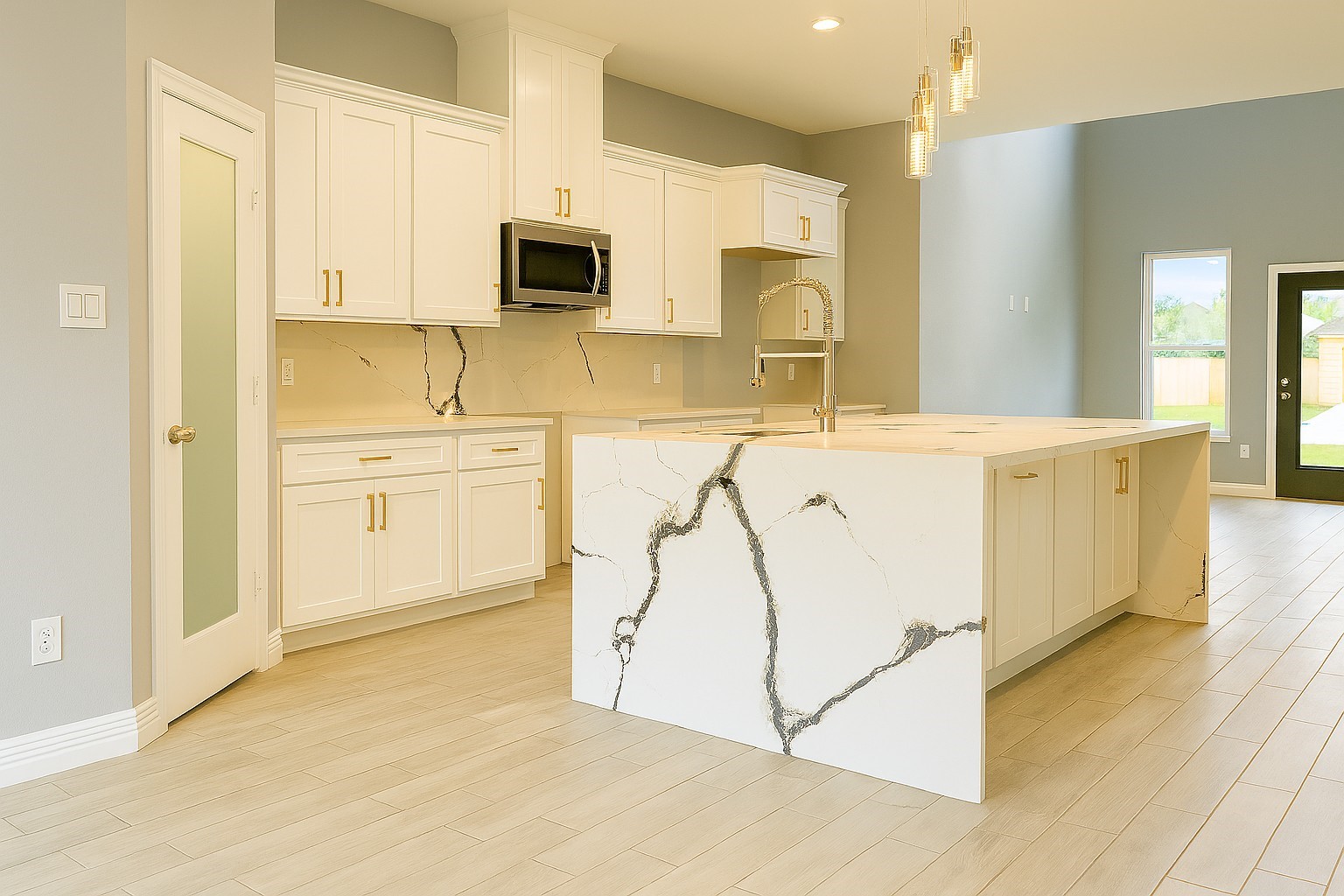 2 Mace Street Conroe, TX 77303 - Photo 6 of 24 Designer kitchen featuring elegant quartz countertops, a striking waterfall island, and abundant cabinetry—ideal for hosting and daily living alike.