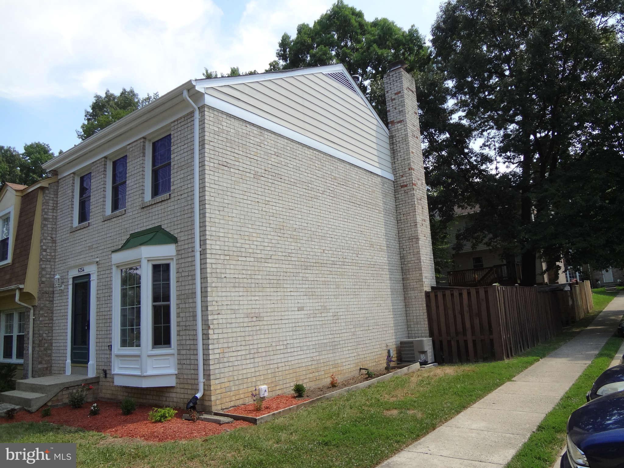 6354 Draco Street Burke, VA 22015 - Photo 20 of 21 a backyard of a house with lots of green space