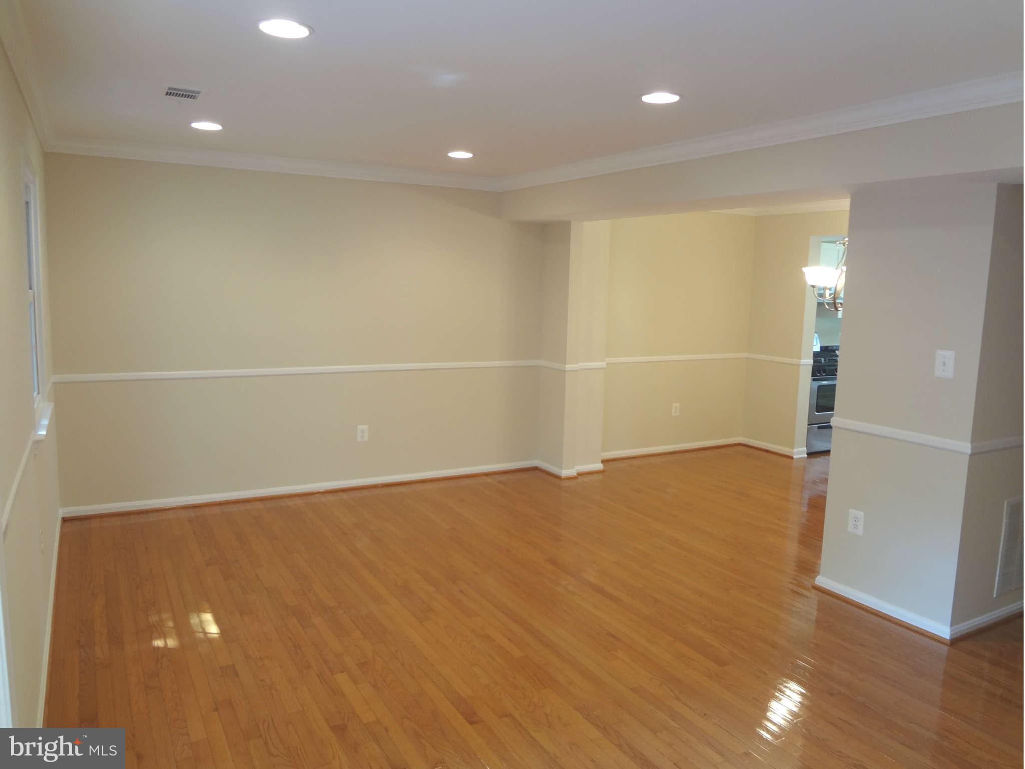 6354 Draco Street Burke, VA 22015 - Photo 3 of 21 an empty room with wooden floor and entrance