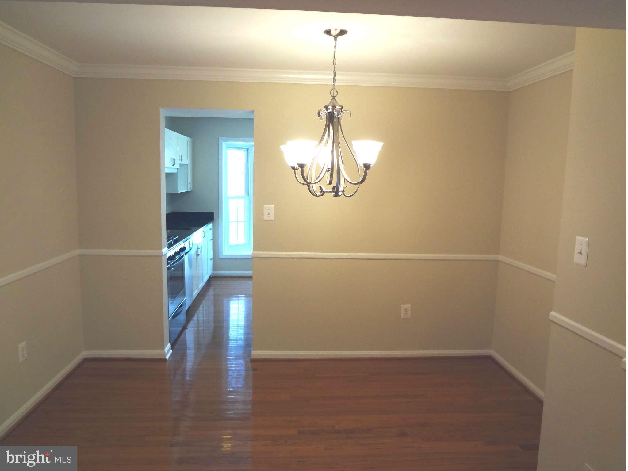 6354 Draco Street Burke, VA 22015 - Photo 4 of 21 a view of a room with wooden floor and staircase