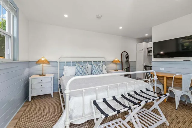 a bedroom with a bed and a television