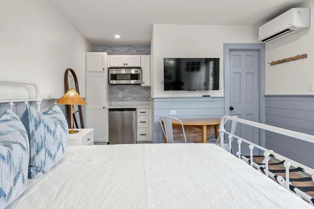 a bedroom with a bed and a flat screen tv