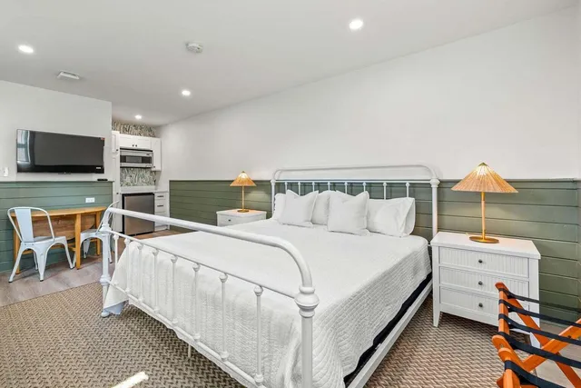 a bedroom with furniture and a flat screen tv