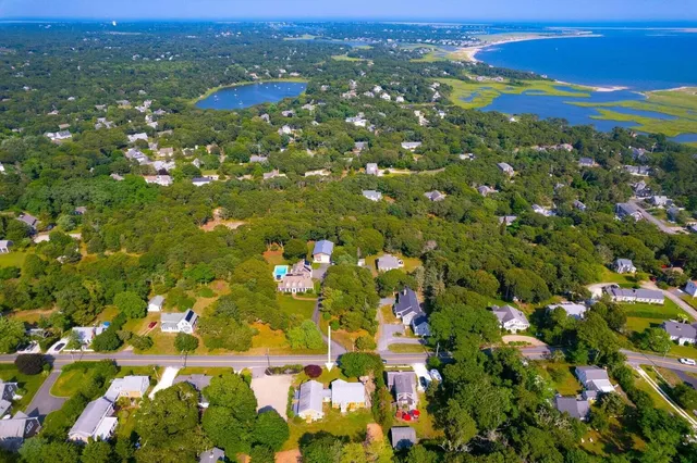 an aerial view of residential house with outdoor space and trees