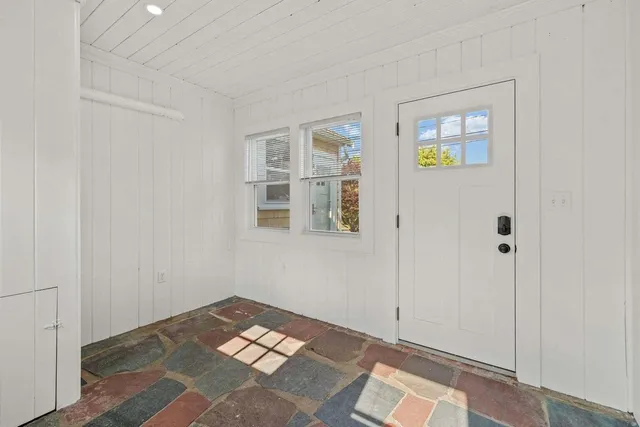 a kitchen with stainless steel appliances a table chairs sink and cabinets