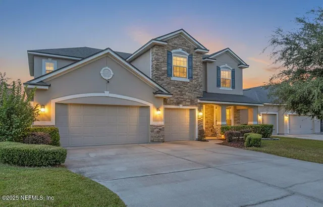 a front view of a house with a yard and garage