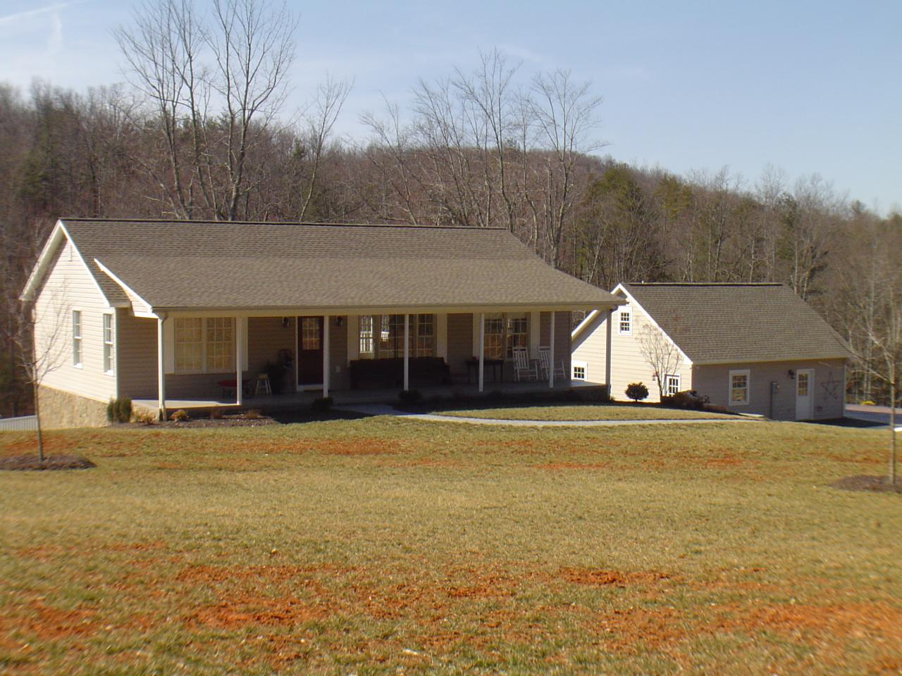 1063 Madcap Road Rocky Mount, VA 24151 - Photo 1 of 39 a front view of a house with a yard and garage