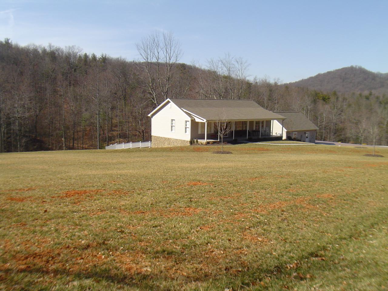 1063 Madcap Road Rocky Mount, VA 24151 - Photo 31 of 39 a view of a house with a yard and a large tree