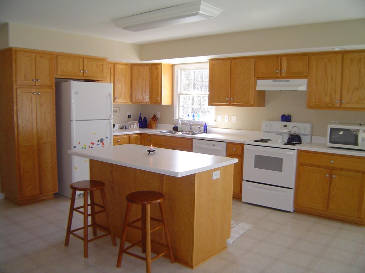 1063 Madcap Road Rocky Mount, VA 24151 - Photo 5 of 39 a kitchen with a sink a stove a refrigerator and cabinets
