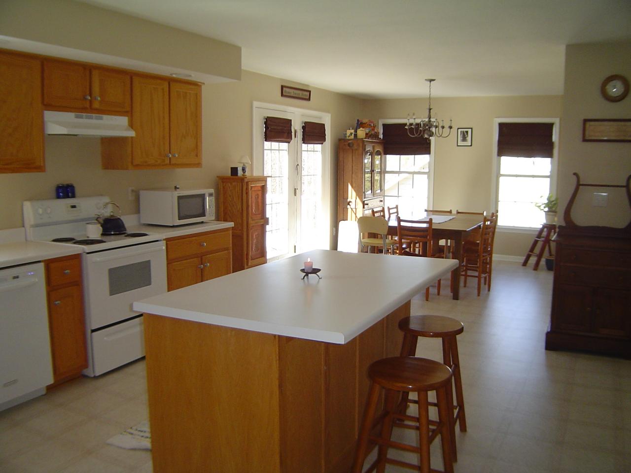 1063 Madcap Road Rocky Mount, VA 24151 - Photo 7 of 39 a open kitchen with stainless steel appliances granite countertop a stove a sink a microwave and a refrigerator