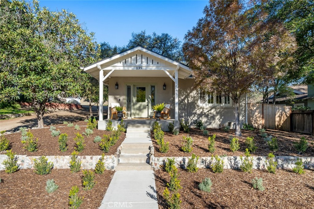a view of a house with garden and sitting area