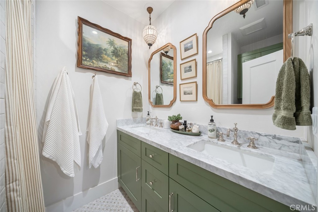 135 18th Street Paso Robles, CA 93446 - Photo 17 of 45 a bathroom with a double vanity sink and a mirror